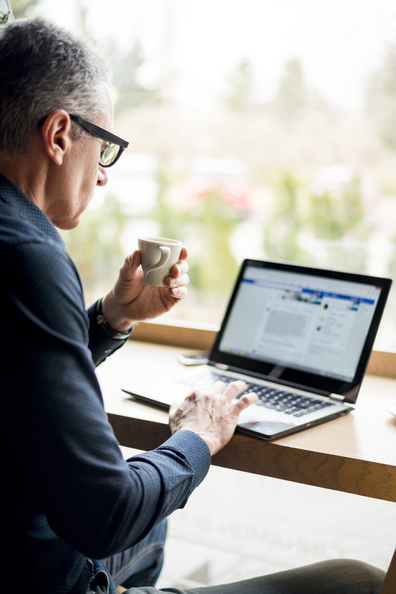 elderly-businessman-working-laptop